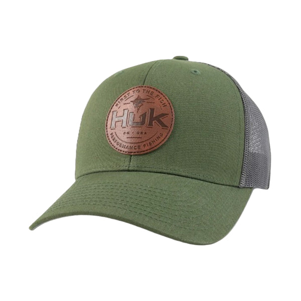 Green trucker hat with a brown leather patch featuring 'HUK' branding on a white background.
