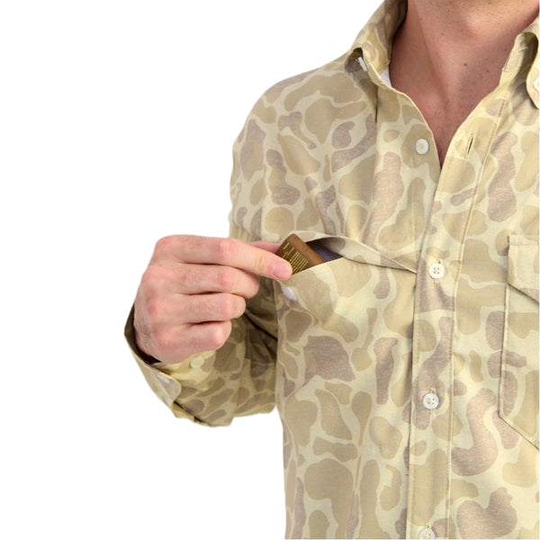 Pocket details of the Huk KC Sand Camo Long-Sleeve Tide Point Shirt on a white background.