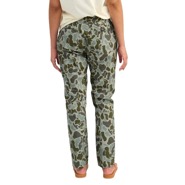 Back of the Huk Women's Cruiser Pants KC Volcanic Camouflage pants worn by a person on a white background.