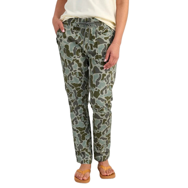 Front of the Huk Women's Cruiser Pants KC Volcanic Camouflage pants worn by a person on a white background