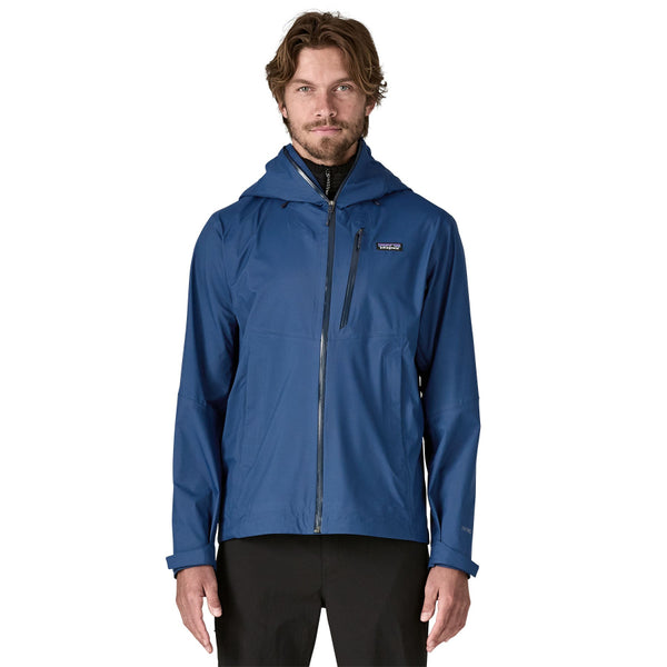 Man wearing the Patagonia Men's Granite Crest Rain Jacket in Clement Blue on a white background.