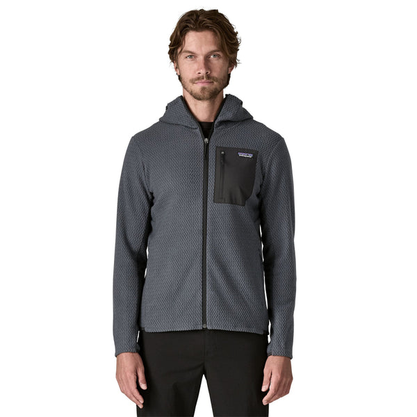 Man wearing a Smolder Blue Patagonia Men's R1 Air Fleece Hoody on a white background.