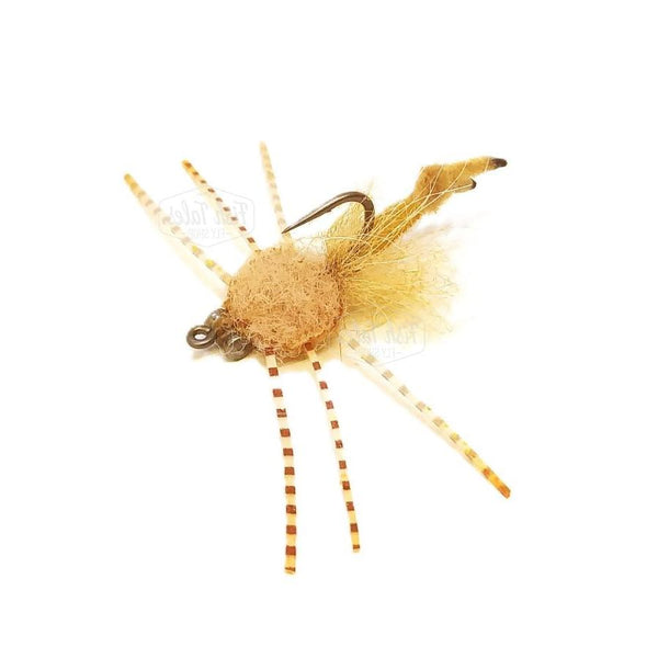 Saltwater Velcro Crab fly with tan furry foam body, tan chenille strong arm, heavy dumbell eyes,and barred orange fire tip sili legs on a white background.