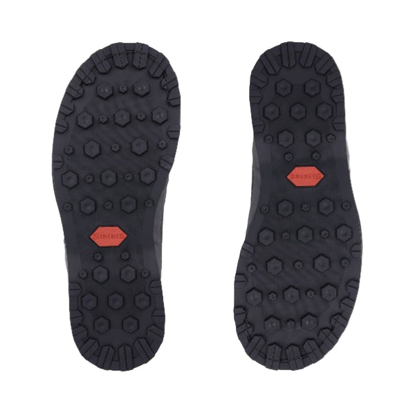 Bottom of the Simms Men's Tributary wading boot showing  rubber sole and the lug pattern on a white background