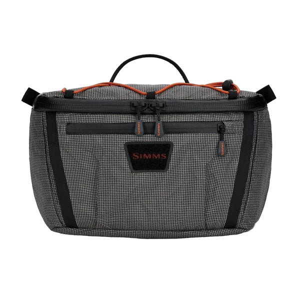 Black and gray Simms Scout Hip Pack bag with orange accents shown from the front on a white background.