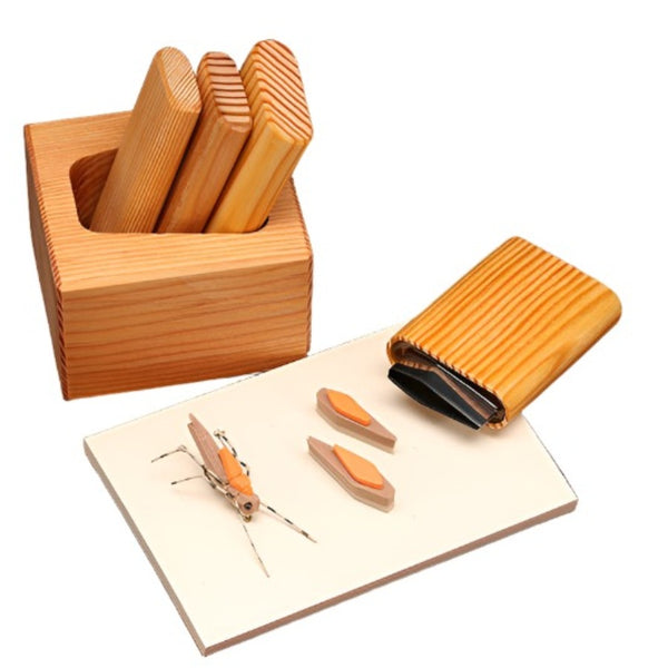 A set of wooden foam body cutters arranged in a matching wooden caddy, with a cutting pad and sample Morrish hopper and cut foam against a white background.