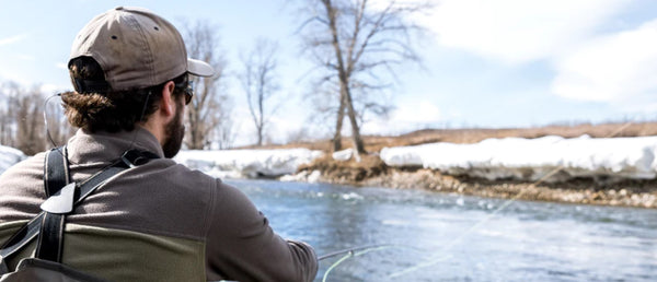 Fish Tales guide angler casting fly line out over a wintery Bow River 