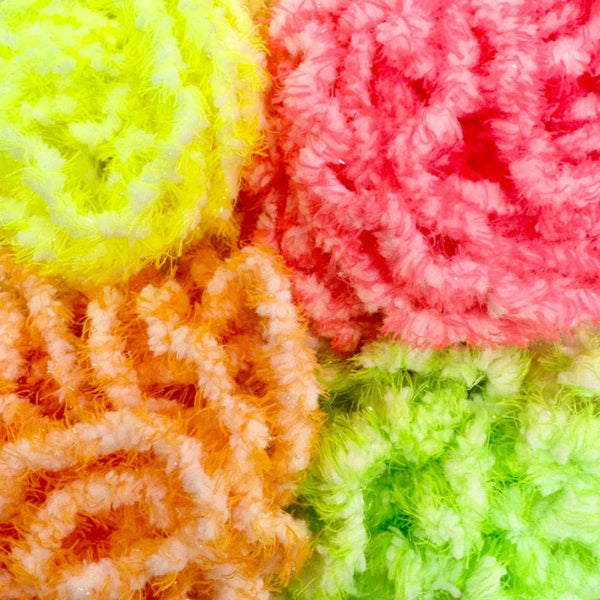 Four fluffy skeins of Upavon Atonic Egg Chenille for fly tying in bright yellow, pink, orange, and lime green, arranged in a close-up collage.