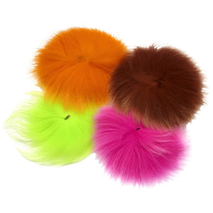 several pieces of brightly dyed arctic fox tail fur for fly tying on white background