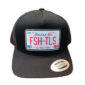 Black trucker cap with 'Fish Tales Fly Shop' Alberta license plate patch, on a white background.