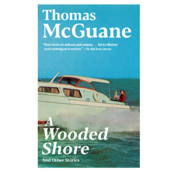 Book cover for 'A Wooded Shore And Other Stories' by Thomas McGuane, featuring title text over a blue sky with a white speedboat carrying a person on a turquoise sea.