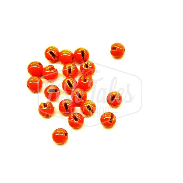 Several fluorescent orange slotted fly tying beads on a white background.