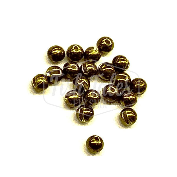 Several metallic olive slotted fly tying beads on a white background.