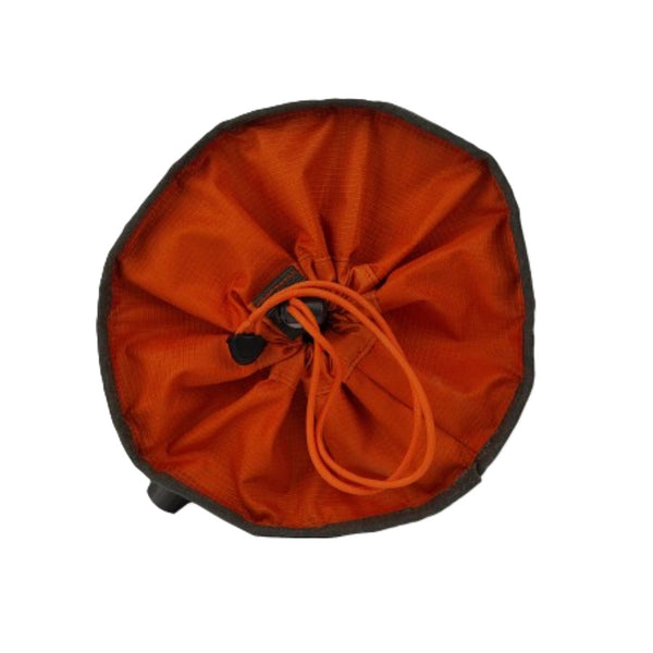 Duskwood Fishpond Bow Wow Travel Food Bowl in overhead view showing closed orange drawstring cover on a white background.