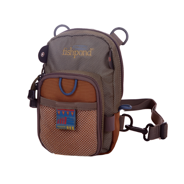 front view of fishpond canyon creek chest pack for fly fishing in saddle brown on white background