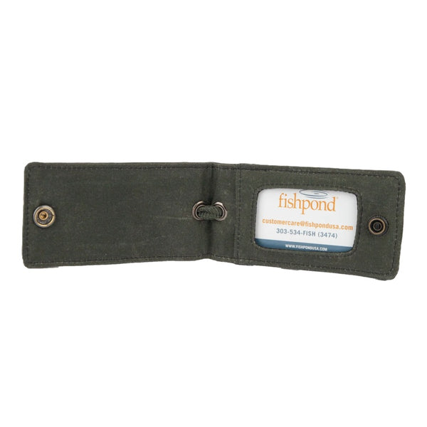 The Fishpond Field Waxed Canvas Luggage tag in Duskwood color open against a white background.