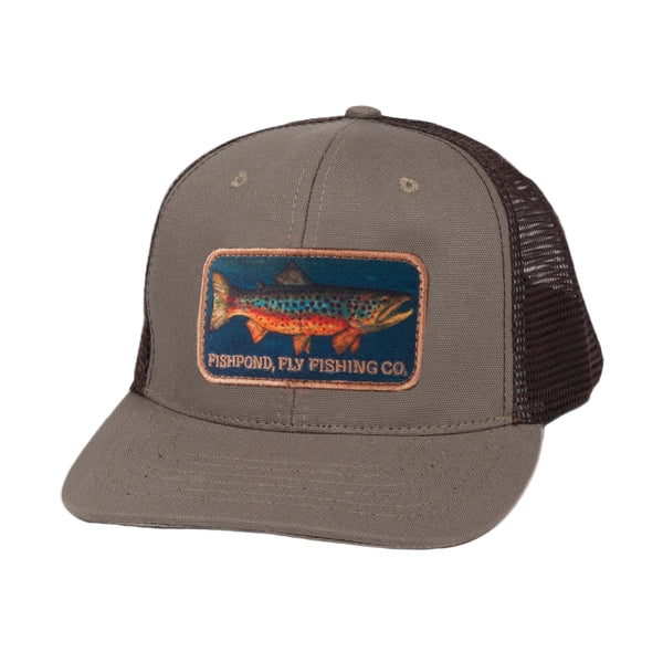 Brown and sandstone tan Fishpond Local Trucker Hat with a trout patch on the front, a white background.