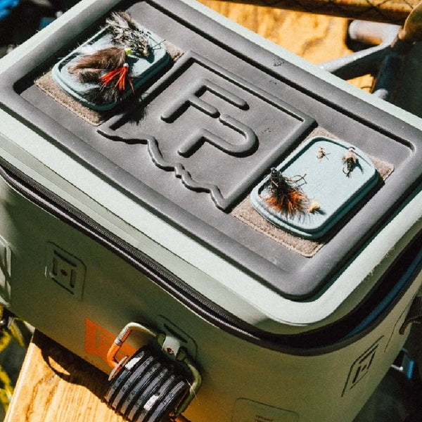 Fishpond boat bag with two Fishpond Tacky Grande Mag Pads in Smoke Grey on top, loaded with flies.