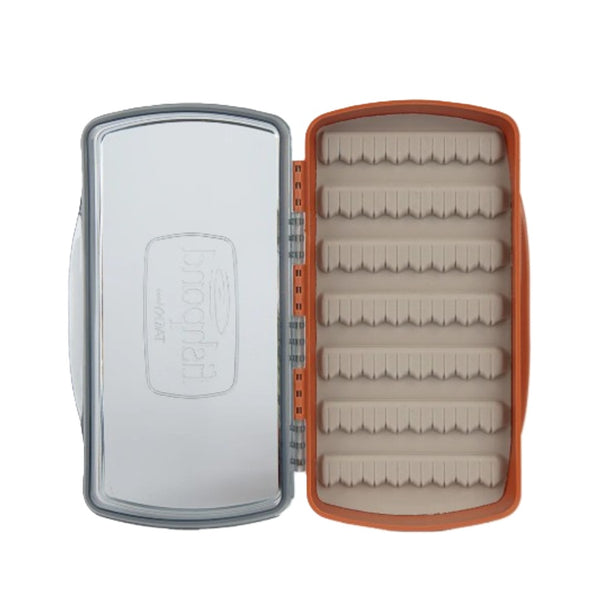 Open burnt orange Fishpond Tacky Pescador Medium Fly Box with clear lid on a white background.