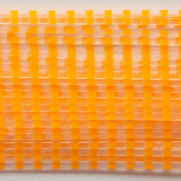 Close up of clear barred orange Fulling Mill Barred Legs for fly tying, on a white background.