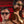 a man and a women wearing Goodr BFG Beelzebub's Bourbon Burpees Polarized Sunglasses on a red background.