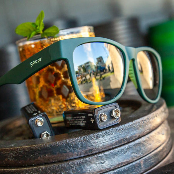 goodr bfg mint julep electroshocks polarized sunglasses with two d batteries and a mint julep in an amber glass 