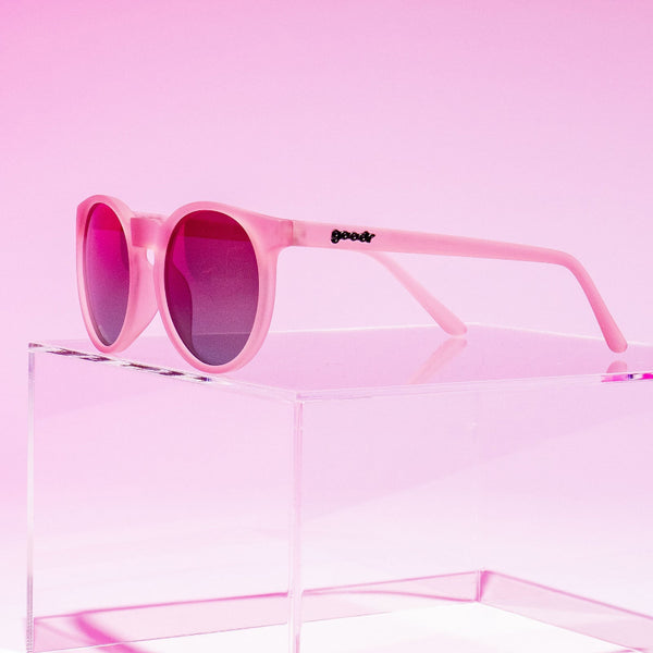 Pink gradient lensed Goodr Circle G Mauve Mood Board sunglasses with a brand logo on a soft pink background.