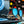 Goodr Circle G Sunglasses with blue lenses and black frame sitting on a record player on a blurred background.