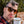 Person holding a coffee cup wearing a plaid shirt and Goodr Circle G Nine Dollar Pour Over Sunglasses with tortoiseshell frame with trees in the background.