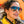 Woman wearing Goodr Mach G Frequent Skymall Shoppers Sunglasses with a reflective orange background.