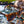 Goodr OG Sunglasses with tortoiseshell frame and dark lenses on a glass table with a nature background.