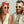 Two people wearing Green Goodr OG Dawn Of A New Sage sunglasses with purple gradient lenses on a white background on a light green background.