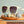 Green Goodr OG Dawn Of A New Sage sunglasses with purple gradient lenses on wooden shelf with seashells.