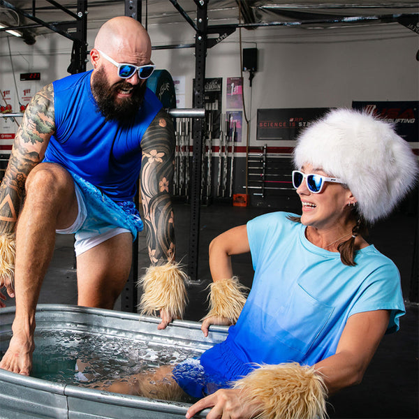 Two people in a gym setting White Goodr OG Iced By Yetis sunglasses.