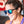 Woman wearing Goodr OG Silverback Squat Mobility Sunglasses with blue lenses and gray frame on a blurred background.