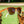 Goodr OG Three Parts Tee Sunglasses with a brown frame sitting on cups of golf tees with a blurred grassy background.