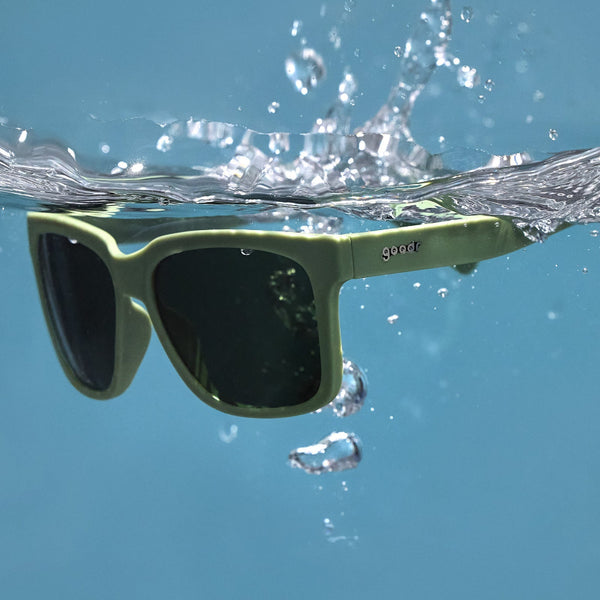 Green Goodr Tidal G Polarized Sunglasses floating on water.