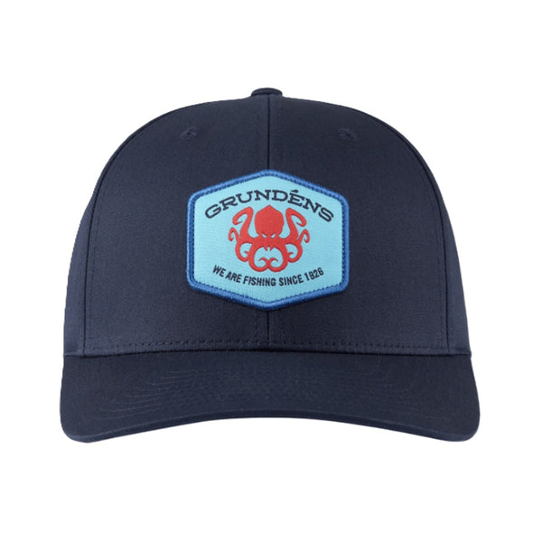 A Grundéns Kracken Classic Solid Twill Trucker Hat in navy blue, showing the custom brand kracken patch on the front, on a white background.