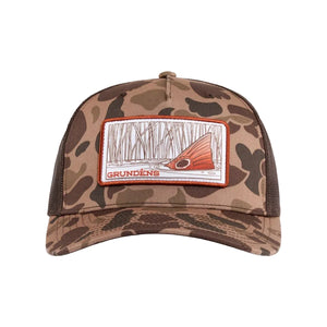 Duck brown camouflage Grundens Redfish Trucker Hat with a custom graphic patch on the front, against a white background.