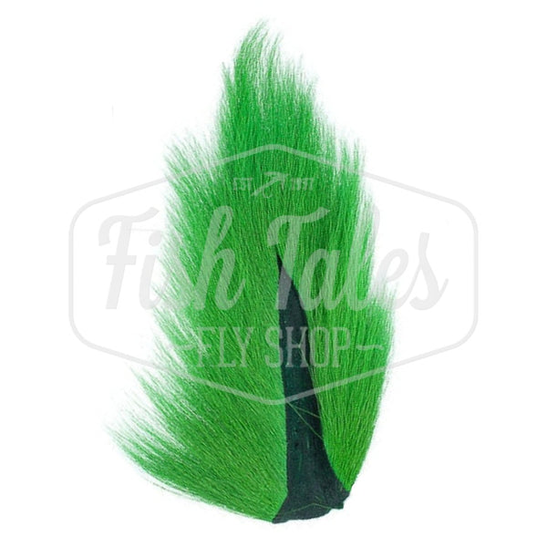 A fluorescent green dyed Hook and Hackle Whole Bucktail for fly tying shown from the underside, on a white background with the Fish Tales logo watermark.