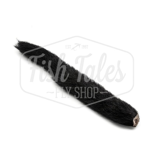 Black whole Hook and Hackle calf tail for fly tying, on a white background.