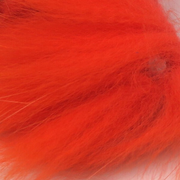 closeup of dyed hot orange arctic fox fur used for fly tying