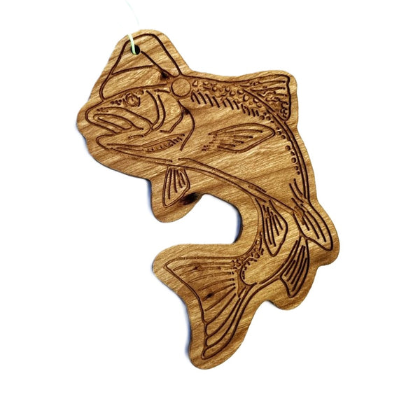 Wooden fish-shaped ornament with engraved trout wearing a santa hat on a white background.