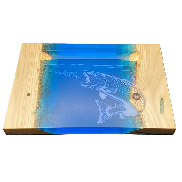 Wooden Hooked By Fishing River Pour Fly Tying Base with blue resin and pearl brown trout carving on a white background.