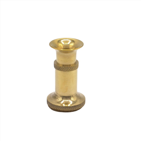A large brass hair stacker used for fly tying on a white background.