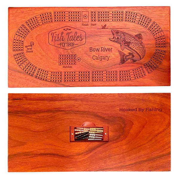 Front and back side of a 4-track wooden cribbage board made with sapele wood with engraved fly fishing design, on a white background.