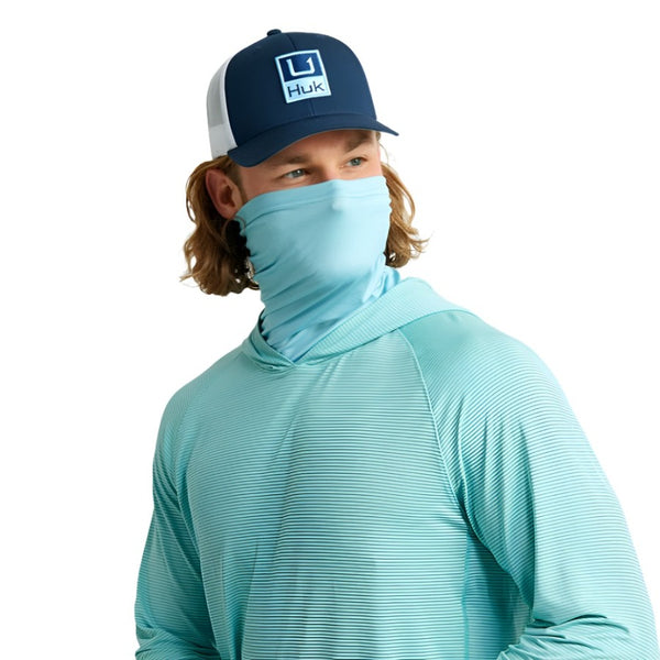 front view of a man wearing a marine blue huk fishing men's a1a performance sun hoody with the built in face gaiter folded up of over the lower face on a white background