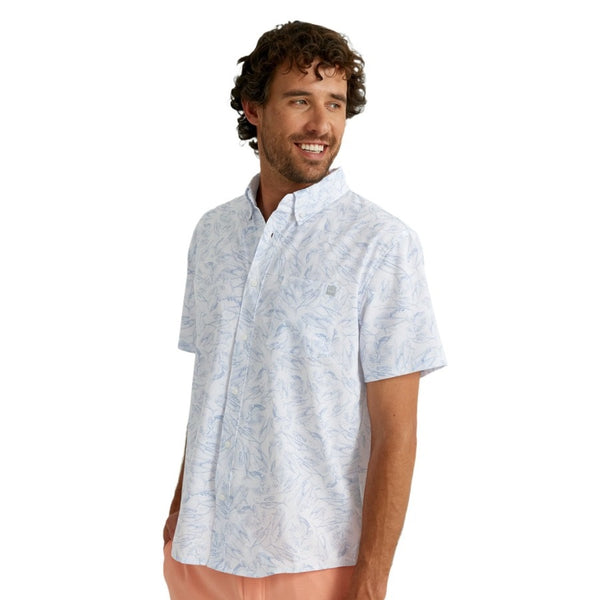 front view of a man wearing a kc fish chaos print white huk fishing men's kona button down short sleeve shirt on a white background