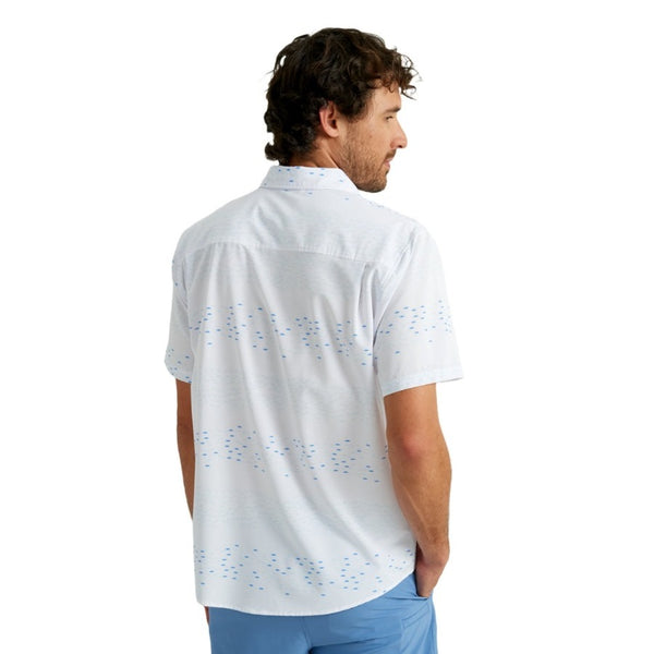 back view of a man wearing an upstream print white huk fishing men's kona button down short sleeve shirt on a white background