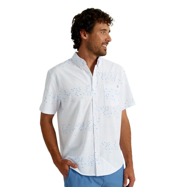 front view of a man wearing an upstream print white huk fishing men's kona button down short sleeve shirt on a white background